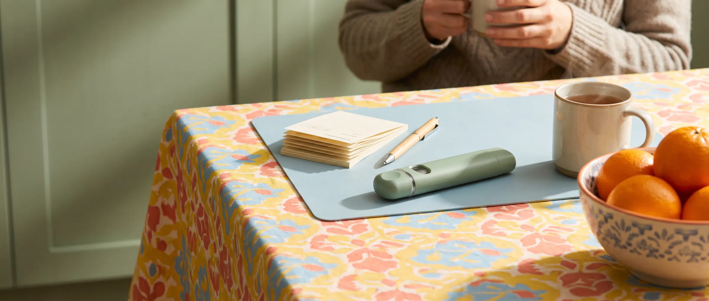 Paper forms, a pen and a plain injection pen on a sunny kitchen table